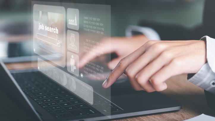 Cropped hands using laptop showing online job search